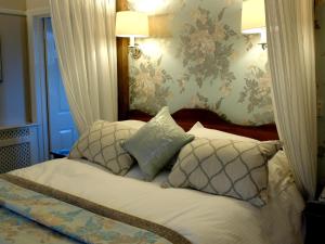 a bedroom with a bed with pillows on it at Bridge Hotel in Buttermere
