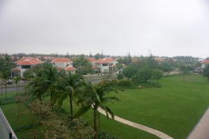 a view of a park with palm trees and houses at Sunshine Apartment in 5* resort in Da Nang