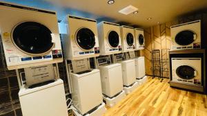 a row of washers and dryers in a room at Route Inn Grantia Aoshima Taiyokaku in Miyazaki