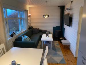 a living room with a couch and a table at Northern Light cottage 1 