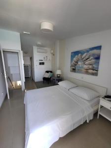a white bedroom with a large white bed in it at Apartment Milena in Drasnice