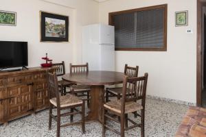 uma sala de jantar com uma mesa e cadeiras e um frigorífico em Apolo, 5º- 30 em Cullera