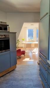 a kitchen and living room with a table and a couch at SchönZeit in Limburg an der Lahn