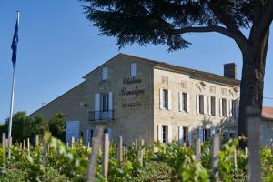 a building with a sign on the side of it at Château Bonalgue - Pomerol in Libourne