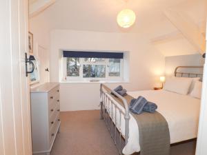 a small bedroom with a bed and a window at Little Barn Cottage in Newport Pembrokeshire