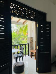 an open door to a patio with a table and chairs at Tropical Vibes - Kathaluwa in Ahangama