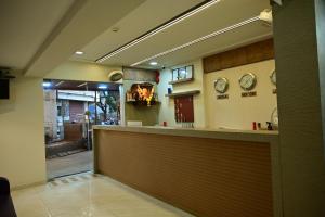 a restaurant lobby with a counter and a view of the street at Hotel Diamora Residency in Thane