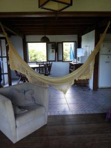 a living room with a hammock in a house at Casa de praia na beira do mar in Florianópolis