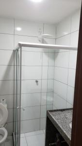 a bathroom with a shower with a toilet and a sink at Monte Castelo - Flat 02A - Módulo 18 in Gravatá