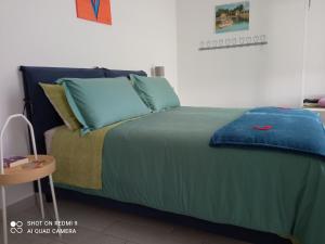 un letto con coperta blu e cuscini sopra di Bella 'Mbriana ad Avellino