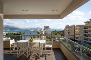 a balcony with a table and chairs and a view at Varkiza Luxury Residence in Varkiza