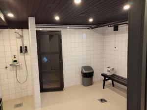 a bathroom with a shower and a bench in a room at Kuhmoisten Kivilinna in Kuhmoinen +10 photos