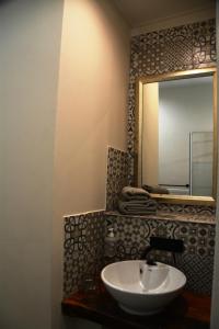 a bathroom with a sink and a mirror at The Corner House Sa in Howick