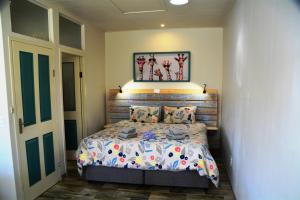a bedroom with a bed with a wooden headboard at The Corner House Sa in Howick