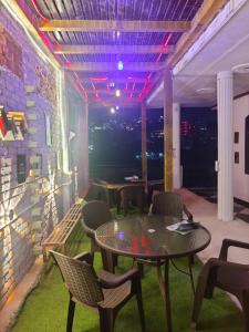 a patio with a table and chairs and lights at Shri Ganga View Guest House in Rishīkesh