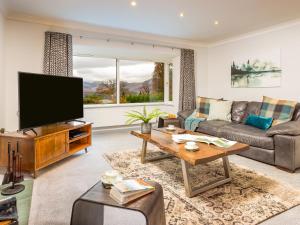 a living room with a television and a couch at Merlestead in Applethwaite