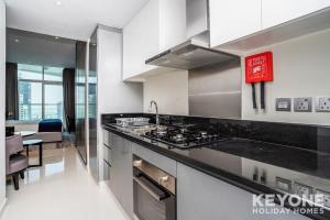 a kitchen with a stove and a counter top at KeyOne - Studio in DAMAC Maison Privé in Dubai