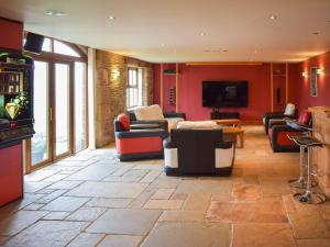 a large living room with couches and a tv at Cote Farm in Langsett