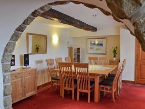 a dining room with a table and chairs at Cote Farm in Langsett