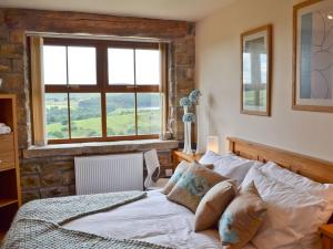 a bedroom with a bed and a window at Cote Farm in Langsett