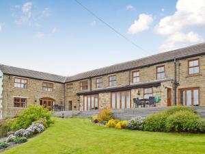 an exterior view of a brick house with a yard at Cote Farm in Langsett