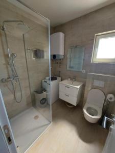 a bathroom with a shower and a toilet and a sink at Apartment in Lokva Rogoznica with sea view, balcony, air conditioning, WiFi 5118-4 in Lokva Rogoznica