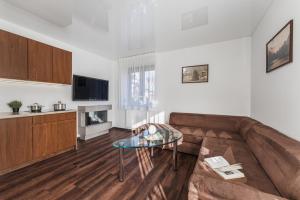 a living room with a couch and a glass table at Apartamenty Eko in Szczawnica