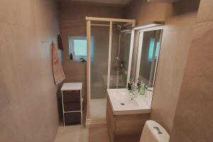 a bathroom with a sink and a shower and a toilet at Koselig leilighet i gangavstand til Ullernåsen T-bane stasjon in Oslo +18 photos
