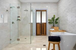 a bathroom with a tub and a sink and a shower at Unique and secluded Poppy Cottage in Bilpin +23 photos