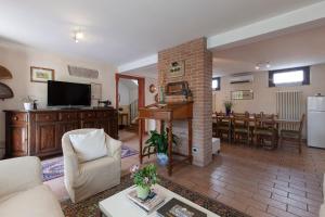 a living room with a fireplace and a dining room at COUNTRY HOUSE CASAMIRIAM in Mirano