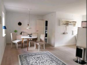 a kitchen and dining room with a table and chairs at Birkevang holiday apartment in idyllic countryside in Faxe
