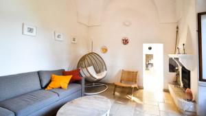 a living room with a blue couch and a table at Casa Litali by Rentbeat in Ostuni