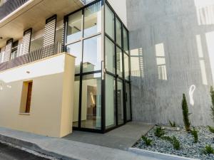 a house with glass doors on the side of it at Armonta Residences by BeCyprus in Limassol