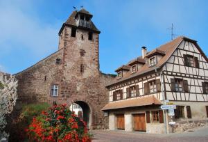 an old building with a tower on top of it at GÎTE DE LA FONTAINE in Wangen