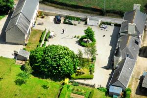 an aerial view of a park with a building and a church at Manoir de Turqueville les Quatre Etoiles in Turqueville