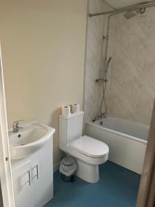 倫敦的住宿－Valentines Inn，白色的浴室设有卫生间和水槽。