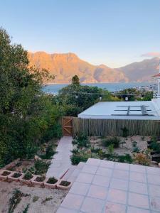 a patio with a view of the water and mountains at BEAUTIFUL VIEW Garden Apartment in Cape Town