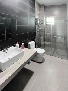 a bathroom with a sink and a toilet and a shower at 53 Mountainville Semi-D Bungalow-13-18pax in Ipoh
