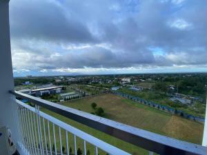 a balcony with a view of a field of grass at Bella Suites at Wind Residences Tagaytay in Tagaytay
