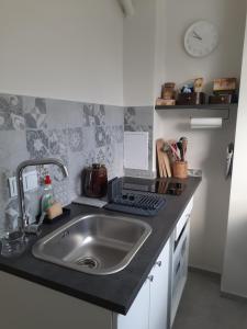 a kitchen with a sink and a counter top at Apartament Tade in Sopot