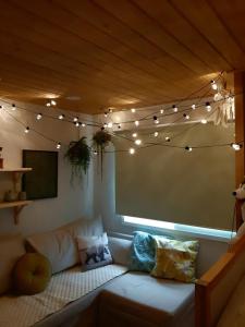 un soggiorno con divano e luci a corda di Mapo Rooftop camping house a Seul