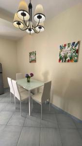 a dining room with a white table and chairs at Monolocale & Suite Casa Santicelli Maratea in Maratea +2 photos