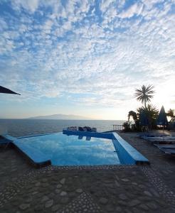 a swimming pool with a view of the ocean at Apartments Romario in Sarandë