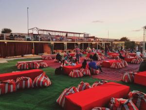 a group of red and white bean bags on the grass at Dream Night Tourism LLC in Hunaywah