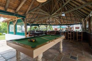 a pool table in the middle of a room at Plotsklaps Self Catering Cottage in Tokai