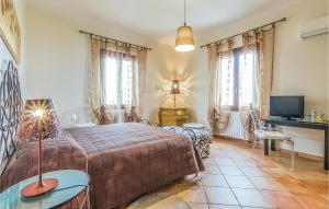 a bedroom with a bed and a desk and a television at Casale Delle Rose in Lendinara