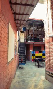 een lege hal met een trap in een bakstenen gebouw bij Happy Donkey hostel in Kathmandu