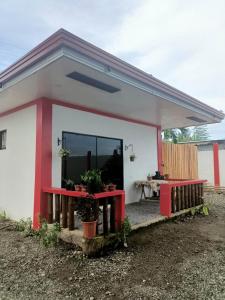 a small house with a red and white at Portofino Homestay in Malitbog