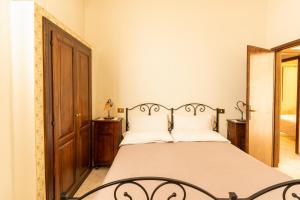 a bedroom with a bed and a mirror at Agriturismo Il Giglio in Oristano
