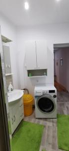 a kitchen with a washing machine and a sink at Center Haus in Bucharest